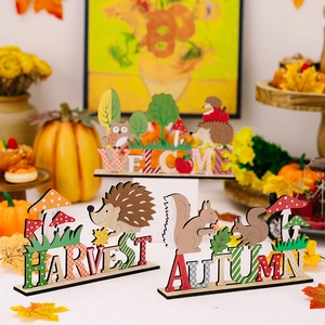 Detailed view of autumn harvest wooden table decor with welcome lettering and forest animals