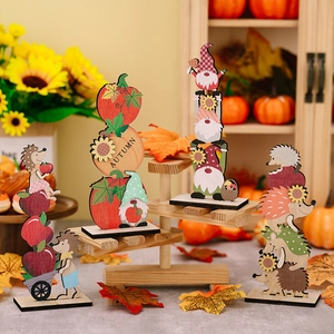 Detailed view of wooden autumn figurines including gnome, pumpkin and hedgehog with base