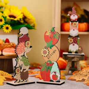 Macro detail of wooden Thanksgiving table ornaments with pumpkin, gnome, and autumn leaves