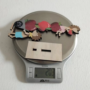 Weight measurement of a wooden Thanksgiving gnome decor showing 20.3 grams on a digital scale