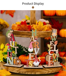 Detailed close-up of autumn harvest wooden gnome and owl tabletop ornaments for home decor