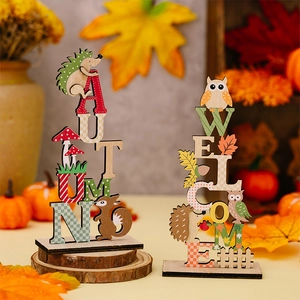 Close-up of autumn wooden table signs featuring squirrel, owl and seasonal leaf motifs