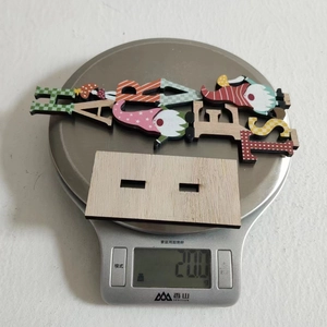 Weight display of wooden owl and squirrel ornament set on a digital scale for home decor