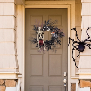 Halloween wreath detail with skeleton, pumpkins, and Happy Halloween sign on front door