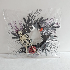 Detail of Halloween wreath with skull, mini pumpkins and Happy Halloween spiderweb sign