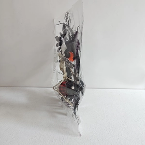 Detailed set of mini skeletons, orange pumpkins, and black branches in packaging