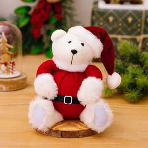 Detail of a white plush Christmas teddy bear wearing a Santa suit on a wooden base