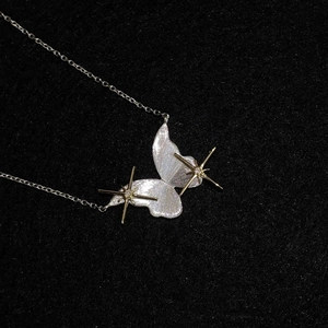 Elegant purple butterfly and star necklace with silver brushed finish on black fabric