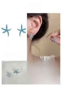 Macro detail of blue starfish stud earrings featuring encrusted crystals and sea style