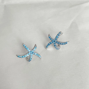 Elegant blue starfish stud earrings with silver metal and sparkling oceanic stones