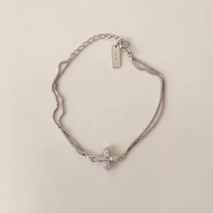 Detail of S925 sterling silver double-layer bracelet featuring a zircon-encrusted cross