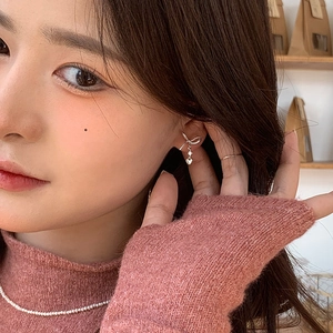 Detail shot of bow-knot heart stud earrings with sparkling cubic zirconia on model