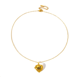 Detail of vintage gold heart locket with Queen Bee engraving and S.STEEL stamp