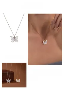 Detail of butterfly pendant necklace with zircon inlay and pearlescent finish