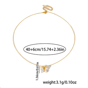 Detailed view of butterfly pendant with stone inlay and adjustable gold-tone chain specs
