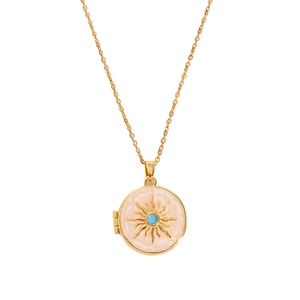 Vintage gold oval locket necklace with pink enamel sunburst and blue bead on white background