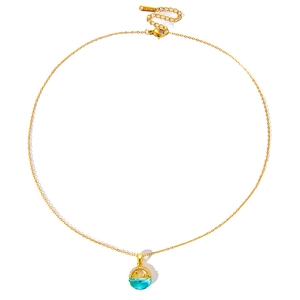 Detail of gold stainless steel necklace featuring a moon and star mermaid tail pendant