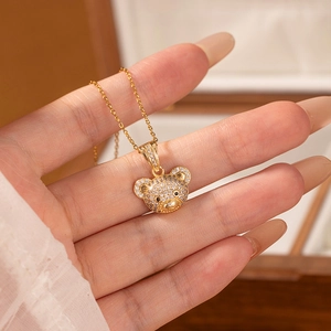 Exquisite gold bear pendant necklace with sparkling micro-pave crystals and black stone eyes