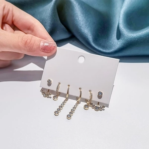 Parure de boucles d'oreilles dorées avec fleurs en perles et clous en étoile sertis de zircons