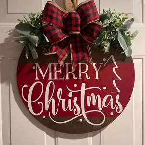Christmas round wooden door sign with red bow, eucalyptus leaves and Merry Christmas text