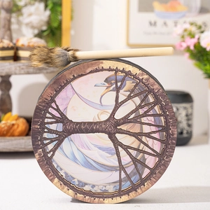 Detail of Shaman drum featuring Tree of Life pattern and decorative wooden mallet