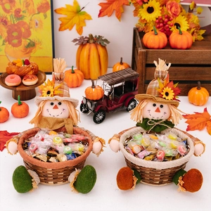 Close-up of scarecrow candy baskets with sunflower and maple leaf autumn decorations