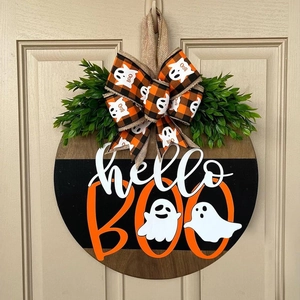 Detail of wooden Halloween door sign with hello BOO text and orange plaid bow decoration