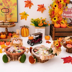 Detailed view of harvest scarecrow candy baskets with Happy Harvest sign and autumn decor