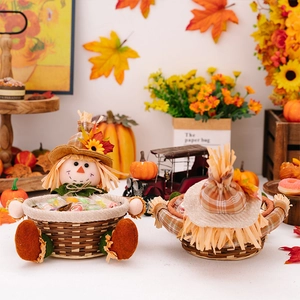 Detail of autumn scarecrow candy baskets with straw base and festive fabric decorations