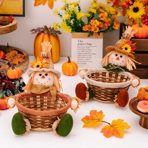 Close-up of Thanksgiving scarecrow candy baskets with autumn leaf and sunflower decorations