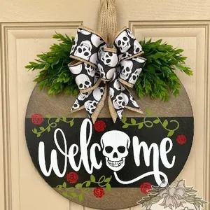 Detail of Halloween welcome door sign with skull bow, roses and artificial greenery