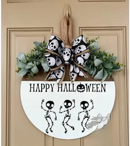 Detail of Halloween wooden door sign featuring happy skeletons and a decorative bow