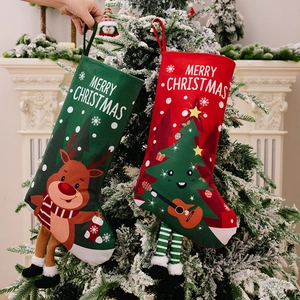 Set of red and green Christmas stockings with 3D dangling legs and reindeer prints