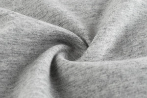 Macro detail of soft grey melange knitted cotton fabric showing texture and fibers