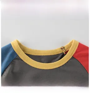 Detail view of contrast crew neck and raglan stitching on cotton kids t-shirt