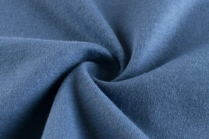 Detailed macro view of soft dark blue knit cotton fabric texture for boys t-shirt