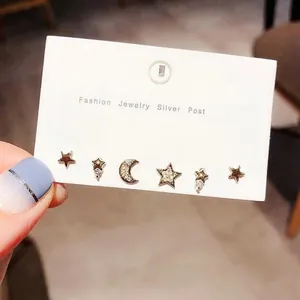 Detail of six-piece star and moon earring set featuring silver posts and crystal accents