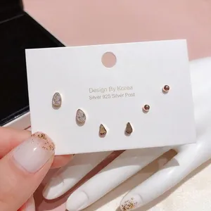 Detailed close-up of geometric S925 silver stud earring set with polished silver finish