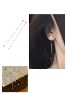 Detail of French style butterfly tassel earrings in gold and silver finish