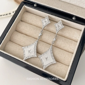 Brushed silver rhombus earrings with engraved star patterns and cubic zirconia accents