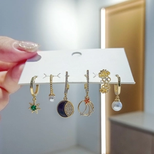 Detail of 6-piece earring set featuring gold-toned stars, moon, and zircon stones