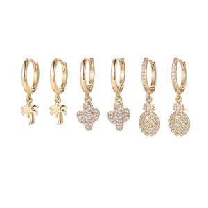 Detailed view of gold tropical earring set featuring palm tree, cactus and pineapple charms