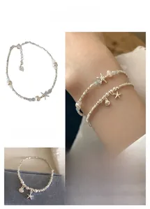 Detailed view of S925 starfish pearl bracelets with light blue beads and silver charms
