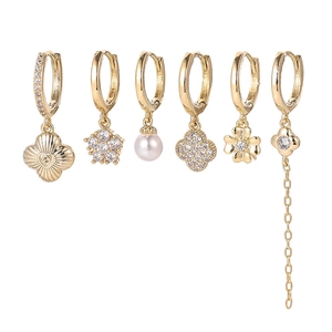Detailed view of 6-piece gold earring set with star, moon, and clover charms