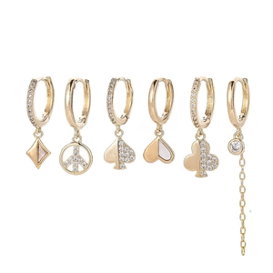 Detailed close-up of a 6-piece gold earring set with star, heart, and zircon charms