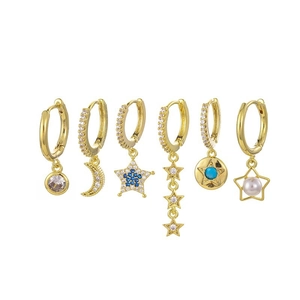 Detail of 6-piece gold earring set featuring moon star and zircon designs on white background