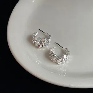 Minimalist silver multi-layered C-shaped stud earrings with geometric textured surface