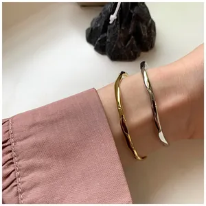 Irregular hammered texture bangles in gold and silver finish with liquid metal effect