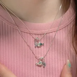 Silver fish pendant necklace set with light blue teardrop beads and delicate box chain