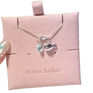 Silver ocean necklace with whale, heart, and blue teardrop zircon pendant on card